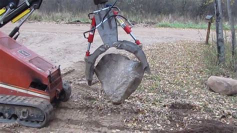 skid steer for moving rocks|how to move rock pipes.